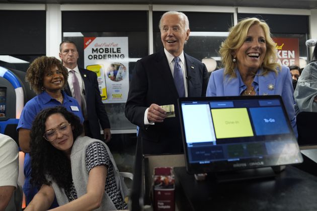 President Joe Biden, center, and first lady Jill Biden, right, pay for a purchase as they greet supporters early Friday at a Waffle House in Marietta following his debate in Atlanta with former President Donald Trump. (AP Photo/Evan Vucci)