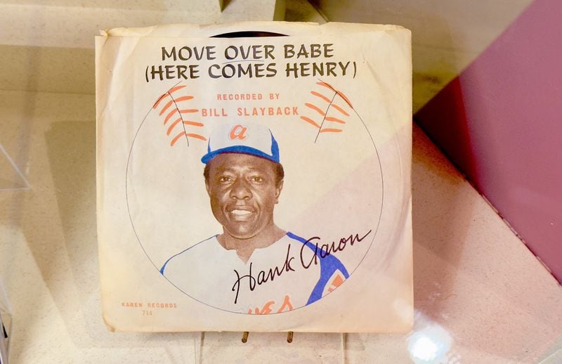 A copy of a vinyl 45 record featuring a novelty song released during Hank Aaron's pursuit of Babe Ruth's home run record is among the items on display through July at the Georgia Sports Hall of Fame in Macon. (Joe Kovac Jr. / AJC)