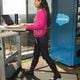 Prlya Pemmasani uses a treadmill desk, next to an IT vending machine, at Salesforce's Atlanta office. Courtesy
