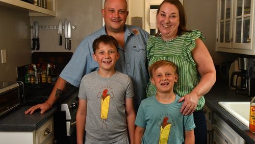 Chef Nick Melvin poses with his wife, Kristen, and sons Pern (left) and Lyle, in the kitchen of their home in Atlanta's Lake Claire neighborhood. (CHRIS HUNT FOR THE ATLANTA JOURNAL-CONSTITUTION)