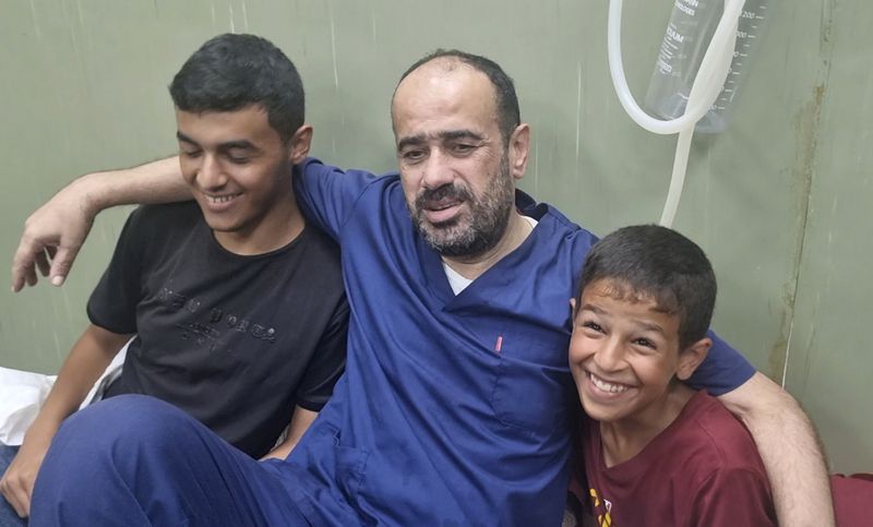 This video grab shows Mohammed Abu Selmia, the director of Gaza's main hospital, who was detained by Israeli forces in November, sitting with his family after his release, along with other detainees, at a hospital in Khan Younis, Gaza Strip on Monday, July 1, 2024. Israel released the director of Gaza's main hospital on Monday after holding him for seven months without charge or trial over allegations the facility had been used as a Hamas command center. He said he and other detainees were held under harsh conditions and tortured. (AP Photo/Mohammad Jahjouh)