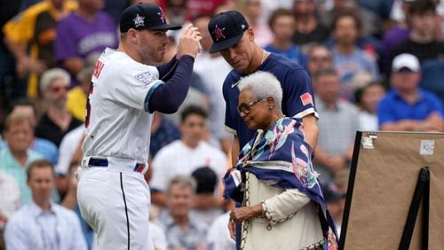 National League's Freddie Freeman, of the Atlanta Braves, left, and American League's Aaron Judge, of the New York Yankees, right, escort the wife of the late Hank Aaron, Billye Aaron, onto the field prior to the MLB All-Star baseball game, Tuesday, July 13, 2021, in Denver. (AP Photo/David Zalubowski)