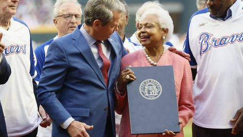 Hank Aaron’s wife, Billye, smiles with Governor Brian Kemp after she was given a proclamation naming April 8th as Hank Aaron Day at Truist Park on Monday, April 8, 2024. Later, the Braves lost the game to the Mets 8-7. 
Miguel Martinez / miguel.martinezjimenez@ajc.com 