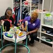 Atlanta Victim Assistance team member Calisha Jones (left) and AVA executive director Shontel Brunson-Wright assemble baby equipment in the nonprofit's supply closet. Courtesy of Atlanta Victim Assistance