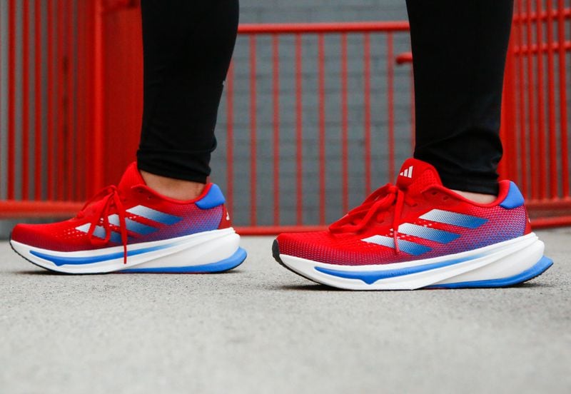 The women's adidas Supernova Rise shoes feature a red-to-blue gradient design.