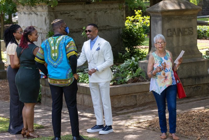 Morris Brown College President Kevin James (center) talks with people after the Historic Oakland Foundation ceremony for the newly restored African American Burial Grounds at Oakland Cemetery on Friday, June 10, 2022. (Steve Schaefer / steve.schaefer@ajc.com)