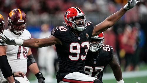 Atlanta Falcons defensive tackle Calais Campbell (93) celebrates his 100th career quarterback sack against the Washington Commanders during the first half of an NFL football game, Sunday, Oct. 15, 2023, in Atlanta. (AP Photo/John Bazemore)