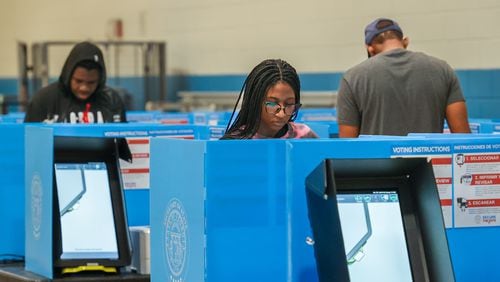 Mariama Dabo (CQ-foreground) casts her ballot at Rhodes Jordan Park in Lawrenceville. PHIL SKINNER FOR THE ATLANTA JOURNAL-CONSTITUTION