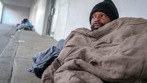 In January, Antwan Slaton bundled up while sleeping on a sidewalk in Atlanta. Slaton spent the night on South Rhodes Center in Midtown at a time when morning temperatures were in the upper teens and lower 20s across the metro Atlanta area. (John Spink / John.Spink@ajc.com)