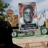 A group of Willie Mays Scholars visit a banner of their San Francisco Giants scholarship program's namesake as they tour historic civil rights-era locations in Birmingham, Ala., on Tuesday, June 18, 2024. (Carlos Avila Gonzalez/San Francisco Chronicle via AP)