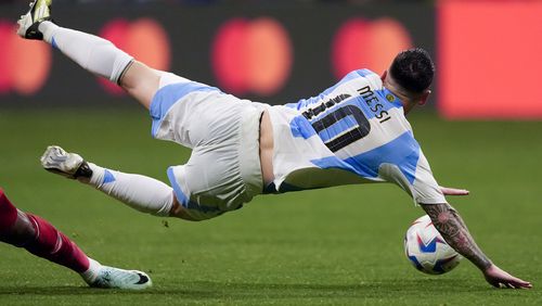 Argentina's Lionel Messi falls during a Copa America Group A soccer match against Canada in Atlanta, Thursday, June 20, 2024. (AP Photo/Mike Stewart)