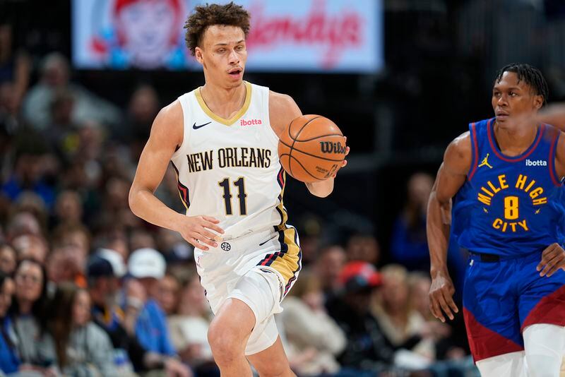 New Orleans Pelicans guard Dyson Daniels, left, pulls in a loose ball as Denver Nuggets forward Peyton Watson pursues in the second half of an NBA basketball game Friday, Jan. 12, 2024, in Denver. (AP Photo/David Zalubowski)