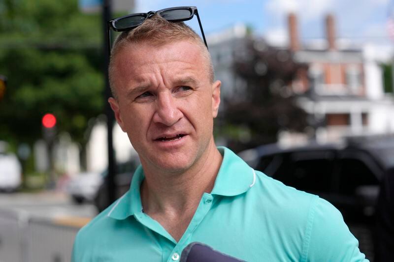 Aidan Timothy Kearney speaks with a reporter outside Norfolk Superior Court, Monday, July 1, 2024, in Dedham, Mass. Kearney, a blogger, has posted articles critical of the prosecution in the Karen Read case. A judge declared a mistrial Monday after jurors deadlocked in the case of Read, who was accused of killing her Boston police officer boyfriend by striking him with her SUV and leaving him in a snowstorm. (AP Photo/Steven Senne)