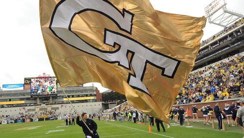 A Georgia Tech cheerleader waves the giant Tech flag following a touchdown.