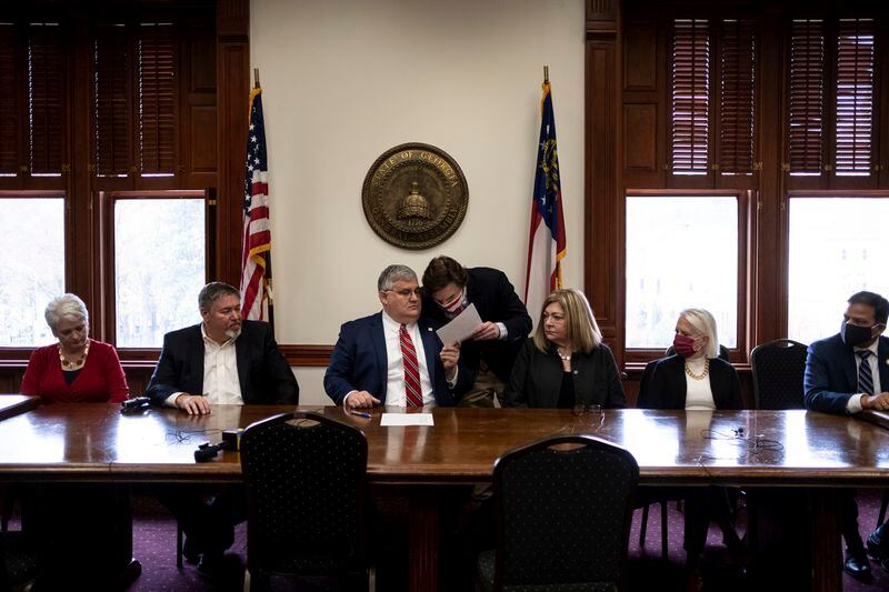 An alternate slate of electors nominated by the Republican Party of Georgia  cast their own electoral votes for President Donald Trump Vice President Mike Pence at the Georgia State Capitol on Monday, Dec. 14, 2020 at the same time the official Democratic electors were casting their votes for Vice President Joe Biden in another part of the Capitol. (AP Photo/Ben Gray)