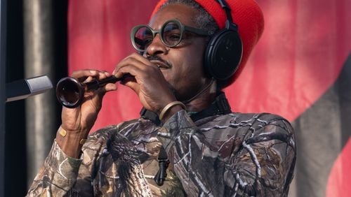 Andre 3000 plays flute onstage at the Atlanta Jazz Festival on May 27, 2024.