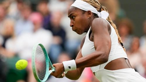 Coco Gauff of the United States plays a backhand return to Anca Todoni of Romania during their match on day three at the Wimbledon tennis championships in London, Wednesday, July 3, 2024. (AP Photo/Mosa'ab Elshamy)