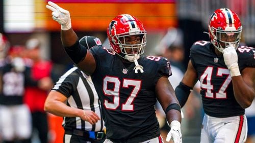 Atlanta Falcons defensive end Grady Jarrett (97) signals during the first half of an NFL football game against the San Francisco 49ers, Sunday, Oct. 16, 2022, in Atlanta. (AP Photo/Danny Karnik)