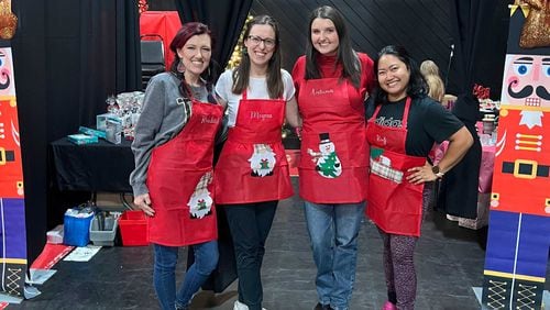 Rachael Henderson (left), with other moms at the War Hill Christian Academy Christmas store. Henderson is among those who say the money they raised was stolen. (Courtesy photo)