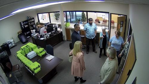 Surveillance video of the Coffee County elections office shows Cathy Latham, a Republican Party fake elector, speaking to computer analysts as they copied election data on Jan. 7, 2021. From left: computer analysts Paul Maggio, Jennifer Jackson and Jim Nelson of the data firm SullivanStrickler; Latham; Ed Voyles, a former Coffee County elections board member; Misty Hampton, the county's elections director; and Eric Chaney, a Coffee County elections board member. Source: Coffee County