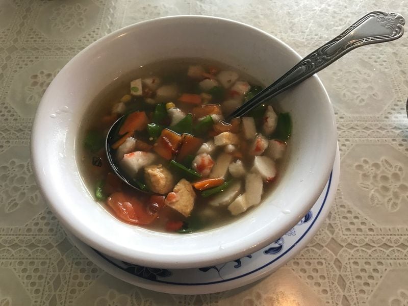 The spicy chili soup at Harmony Vegetarian is a thick, flavorful broth dotted with bits of corn, carrots, pea pods, tofu and big chunks of imitation shrimp. CONTRIBUTED BY LIGAYA FIGUERAS / LFIGUERAS@AJC.COM