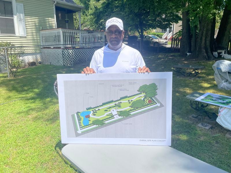 Eric Smith shows off a sketch that serves as the vision for his "literacy garden" in Chattanooga, TN. The sketch was drawn by a landscape architect he struck up a conversation with while visiting a North Georgia bank. (Photo Courtesy of Mark Kennedy)