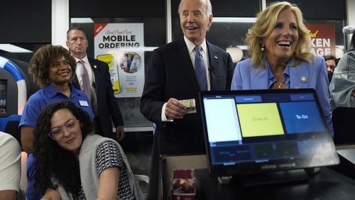 President Joe Biden, center, and first lady Jill Biden, right, pay for a purchase as they greet supporters early Friday at a Waffle House in Marietta following his debate in Atlanta with former President Donald Trump. (AP Photo/Evan Vucci)