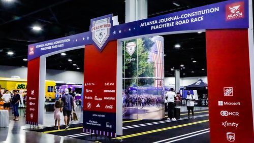 Runners arrive at the 2023 Peachtree Health and Fitness Expo at the Georgia World Congress Center in Atlanta.