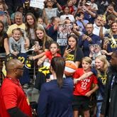 Indiana Fever guard Caitlin Clark, center, signs autographs for fans before the Fever game against the Atlanta Dream at State Farm Arena, Friday, June 21, 2024, in Atlanta. (Jason Getz / AJC)
