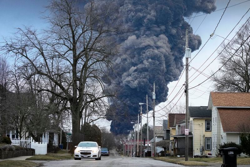 FILE - A black smoke plume rises over East Palestine, Ohio, after a controlled detonation of part of the derailed Norfolk Southern trains, Feb. 6, 2023. A watchdog group says the Environmental Protection Agency should have conducted additional soil studies around the site of the derailment and tested garden crops after independent testing found high levels of chemicals in locally grown garlic. The Government Accountability Project filed a formal petition on Thursday, June 13, 2024 with the EPA. (AP Photo/Gene J. Puskar, file)