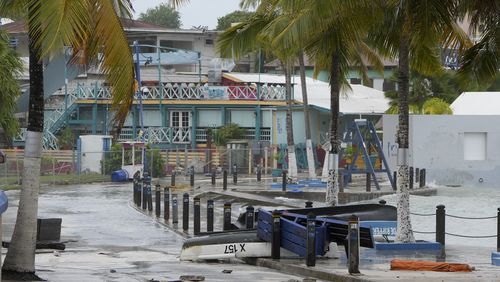 Boats lie capsized in a flooded street after Hurricane Beryl passed through St. Lawrence, Barbados, Monday, July 1, 2024. (AP Photo/Ricardo Mazalan)