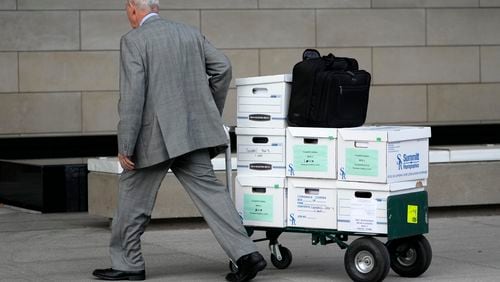 Case documents are wheeled into federal court Monday, June 17, 2024, in Los Angeles.  (AP Photo/Damian Dovarganes)