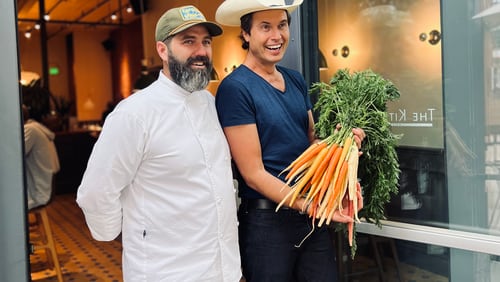 Chef Michael Bertozzi and Kimbal Musk stand in front of The Kitchen, a chain of restaurants co-founded by Musk, based in Boulder, Colo. Musk and Bertozzi, a former executive chef at TWO Urban Licks, visited Atlanta March 14, 2024, for a book-signing event on the release of Musk's first cookbook, "The Kitchen Cookbook," at Virginia Highland Books.