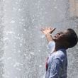 Victor Kupolati, 11, of Duluth, stays cool in the water fountain at the Duluth Town Green, Tuesday, June 25, 2024, in Duluth, Ga. (Jason Getz / AJC)
