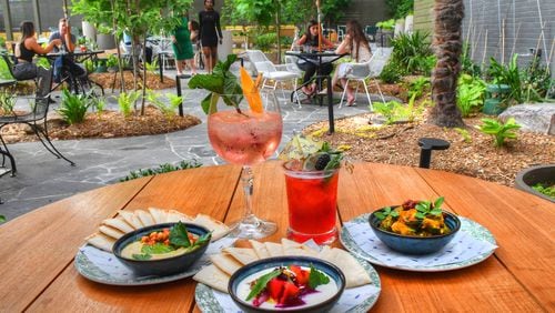 Among the offerings from Willow Bar at Kimpton Sylvan Hotel are, clockwise from top left: the Cypress G&T, Willow cocktail, charred cauliflower and cucumber avocado,  beets and feta, and hummus. CHRIS HUNT FOR THE AJC