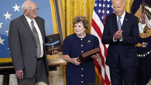 President Joe Biden leads the applause after presenting the Medal of Honor to Theresa Chandler, the great-great-granddaughter of Pvt. George D. Wilson in the East Room at the White House in Washington. Biden also presented a medal to Gerald Taylor, left, the great-grandnephew of Pvt. Philip G. Shadrach. The two soldiers took part in the daring theft of a Confederate train during the Civil War. Each was captured by Confederates and executed by hanging. (AP Photo/Susan Walsh)