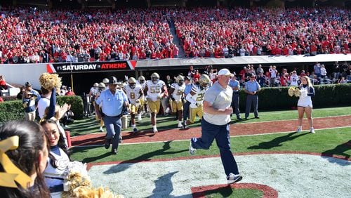 Georgia Tech's interim coach Brent Key and players run on the football field before an NCAA football game between Georgia and Georgia Tech at Sanford Stadium in Athens on Saturday, November 26, 2022. Georgia won 37-14 over Georgia Tech. (Hyosub Shin / Hyosub.Shin@ajc.com)