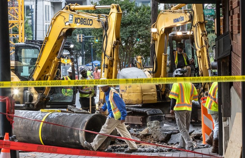 Crews are continuing to work on a broken main on West Peachtree Street at 11th Street in Midtown, with nearby residents warned of impacts to their water service as the crisis reached its fourth day Monday, June 3, 2024. Water had been gushing out of the broken main until Monday morning, when workers were seen pumping out water. (John Spink/AJC)