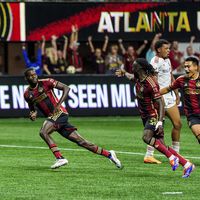 Atlanta United forward Jamal Thiaré, left, midfielder Tristan Muyumba, center, and forward Tyler Wolff, right, celebrate after the winning goal during the second half of an MLS soccer match against Toronto FC, Saturday, June 29, 2024, in Atlanta. (AP Photo/Danny Karnik)