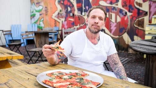 Anthony Spina enjoys a piece of the grandma pie at O4W Pizza. Mia Yakel for The Atlanta Journal-Constitution