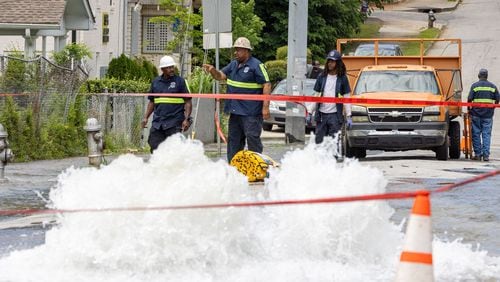 Workers take care of a water main break at Joseph E. Boone Boulevard and James P. Brawley Drive in Atlanta on Friday, May 31, 2024. (Arvin Temkar/The Atlanta Journal-Constitution/TNS)