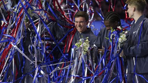 Brody Malone, center left, celebrates alongside Khoi Young, second from right, and and Shane Wiskus as streamers are dropped after they were named to the 2024 Olympic team at the United States Gymnastics Olympic Trials on Saturday, June 29, 2024, in Minneapolis. (AP Photo/Abbie Parr)