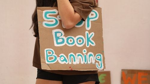 A student holds a sign that reads "Stop Book Banning" at a rally at the Orange County school board meeting in Orlando, Florida, on April 11, 2023. (Carolyn Cole/Los Angeles Times/TNS)