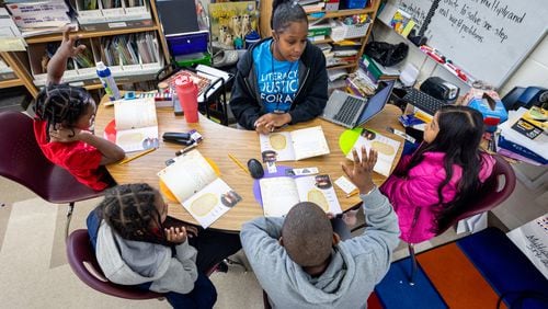 Shamaudie McClendon works with her third grade students on their reading skills at Kimberly Elementary School in Atlanta on Tuesday, Dec. 5, 2023. In the new state budget, Georgia lawmakers inserted nearly $8 million toward literacy mandates they adopted last year. (Steve Schaefer/steve.schaefer@ajc.com)