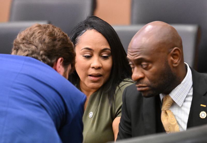 July 1, 2022 Atlanta - District Attorney Fani Willis (center) confers with lead prosecutors, Donald Wakeford (left) and Nathan Wade, during a motion hearing at Fulton County Courthouse in Atlanta on Friday, July 1, 2022. Fulton Superior Court Judge Robert McBurney at a roughly 90-minute hearing Friday did not come to a final decision about what exactly the District Attorney’s office can ask Lt. Gov. Geoff Duncan, former state Sen. William Ligon of Brunswick and several other unnamed state legislators. But he said that anything related to their conversations with other legislators or motivations are off-limits. (Hyosub Shin/hyosub.shin@ajc.com)