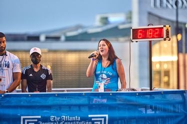 Rachel Norman performs the national anthem ahead of the 2022 Peachtree Road Race.
