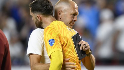 Coach Gregg Berhalter of the United States greets goalkeeper Matt Turner after losing 0-1 against Uruguay at the end of a Copa America Group C soccer match in Kansas City, Mo., Monday, July 1, 2024. (AP Photo/Reed Hoffman)
