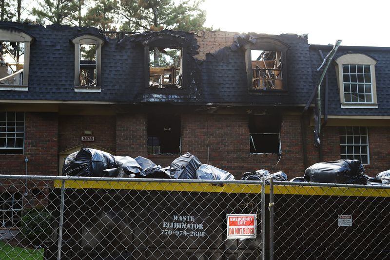 The grounds at The Village at Kensington are blighted by burnt-out apartments, puddles of raw sewage and crumbling balconies.  Local prosecutors have tried for years to get the complex, now called Avondale Village, to make repairs. (Curtis Compton / Curtis.Compton@ajc.com)