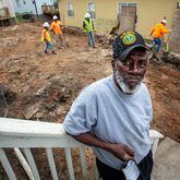 Ellis Smith stands on his porch last week as workers remove dirt from a Westside lead Superfund site in Atlanta's Vine City neighborhood. The cleanup of Smith’s yard is part of a massive EPA effort underway to remove lead from hundreds of Vine City properties, which comprise the Westside Lead Superfund site. (Steve Schaefer for The Atlanta Journal-Constitution)