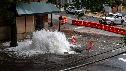 Water spewed out of a broken water main at 11th and West Peachtree streets in Midtown Atlanta on Sunday, June 2, 2024 (Ben Hendren for the Atlanta Journal-Constitution)